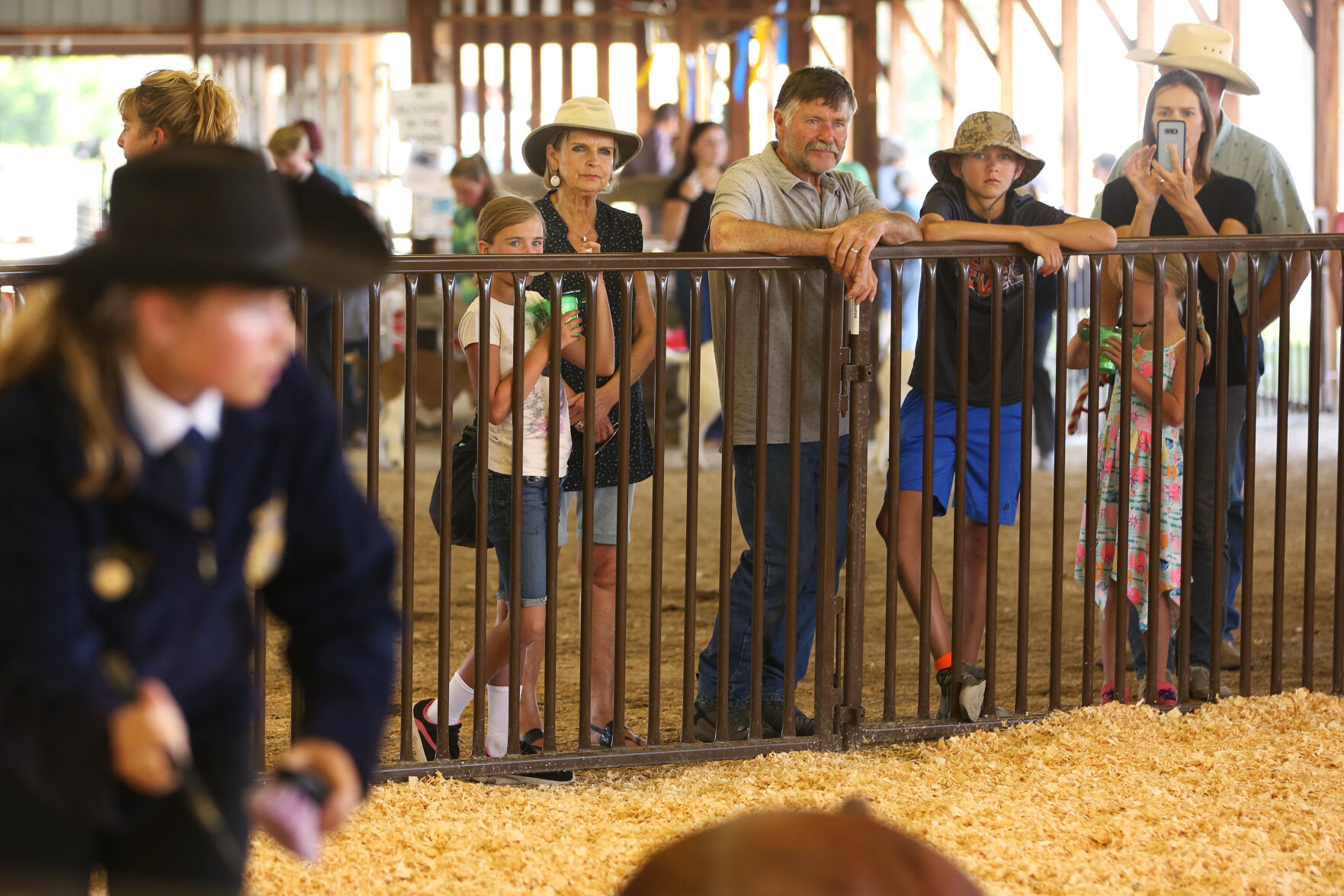 Elsa's family watched as she showed a hog during round robin showmanship competition